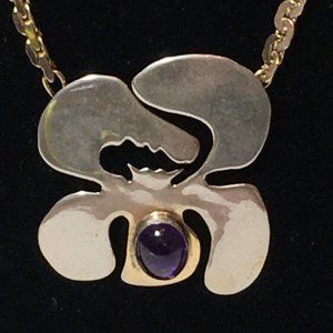 Orchid flower pendant with oval purple stone created by Joanne Cooper in 1970's.